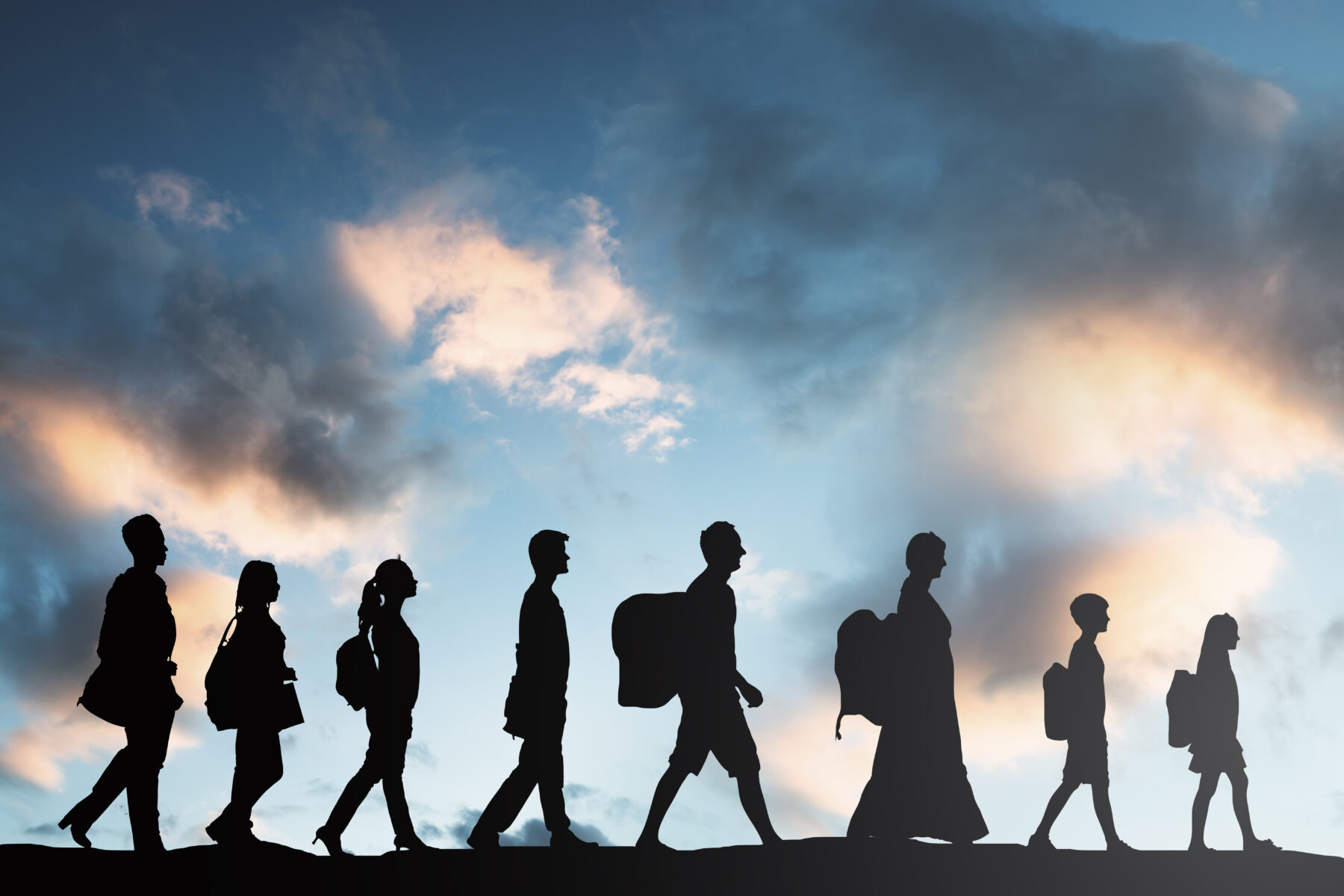 Silhouette,Of,Refugees,People,With,Luggage,Walking,In,A,Row